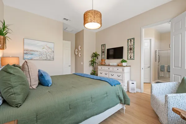 a bedroom with a bed and a television