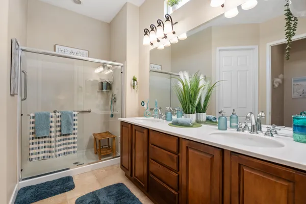 a bathroom with a double vanity sink and a mirror