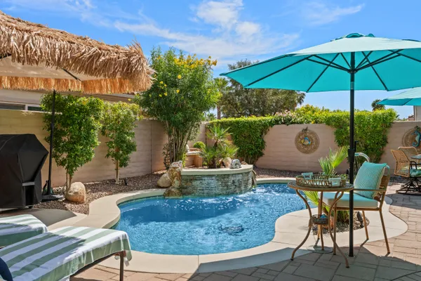 a view of a chairs and table in the patio