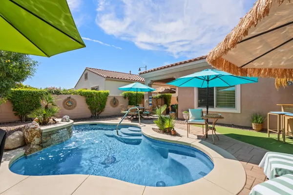swimming pool view with a seating space