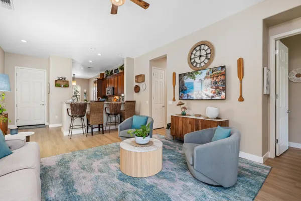 a living room with furniture and a wooden floor