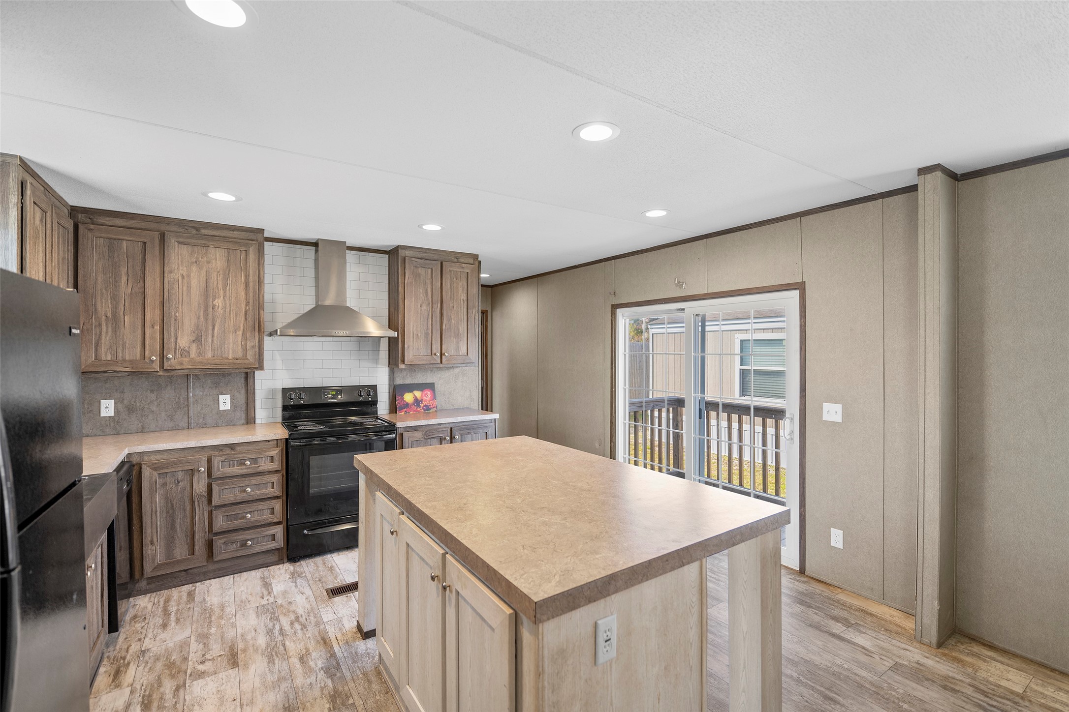 4343 Katy Hockley Road, Unit 27 Katy, TX 77493 - Photo 11 of 27 a kitchen with stainless steel appliances a stove a sink a refrigerator white cabinets and wooden floor