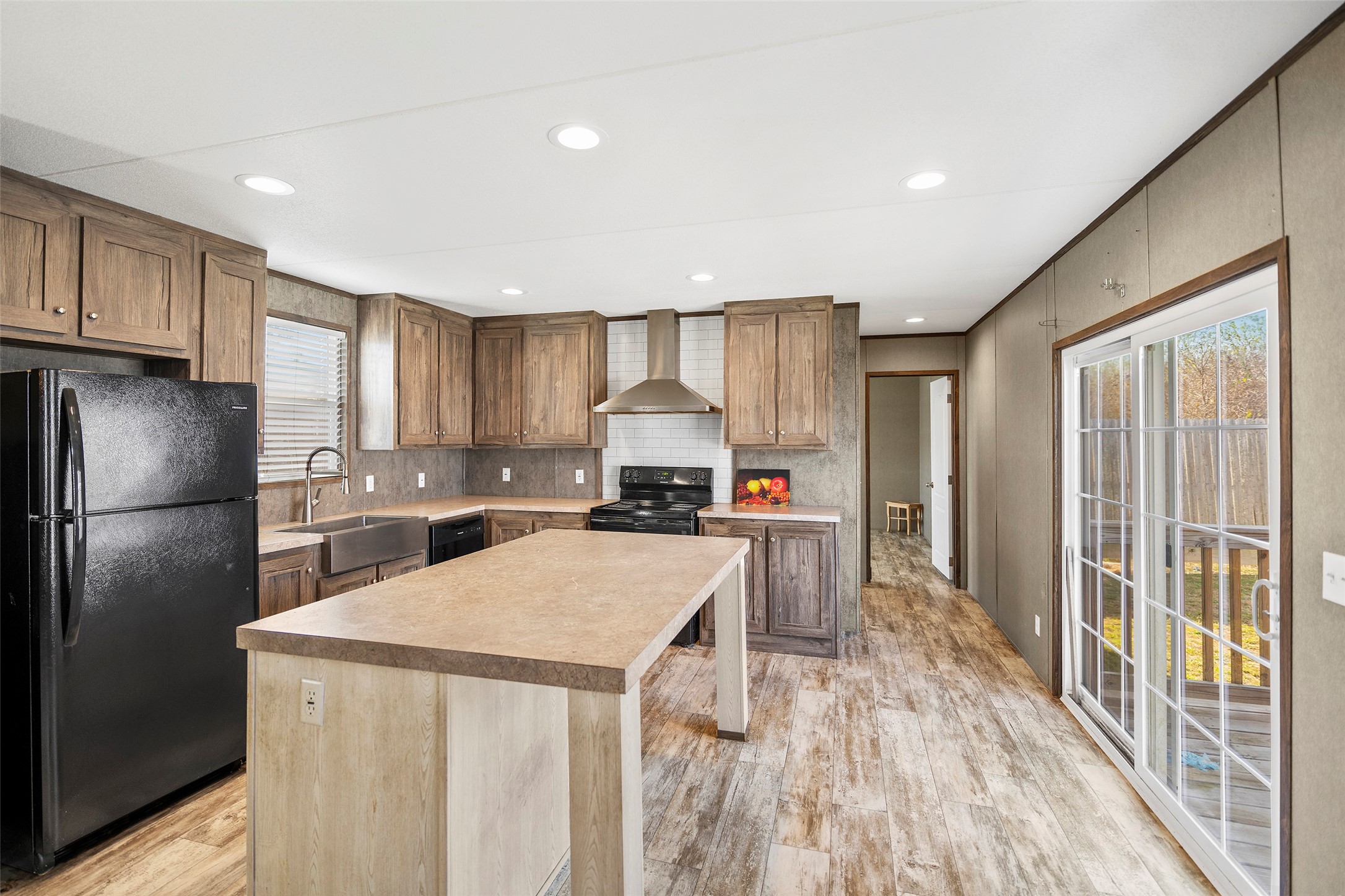 4343 Katy Hockley Road, Unit 27 Katy, TX 77493 - Photo 12 of 27 a kitchen with a refrigerator a stove a sink dishwasher and a oven with wooden floor