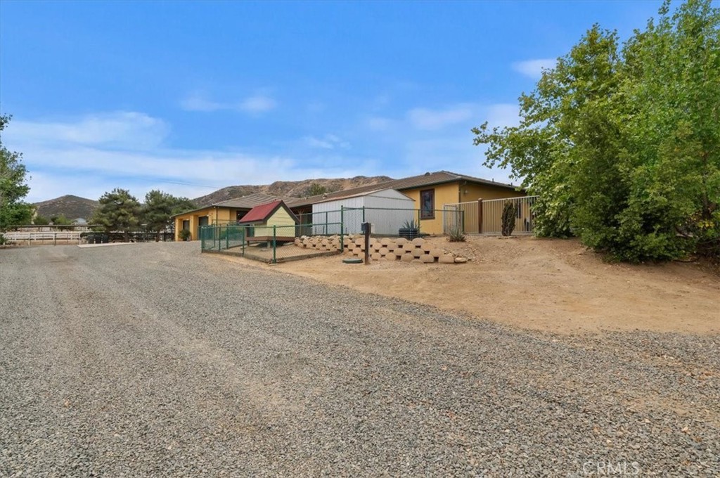 16420 Rocky Glen Road Perris, CA 92570 - Photo 55 of 74 a view of a house with a yard and large trees