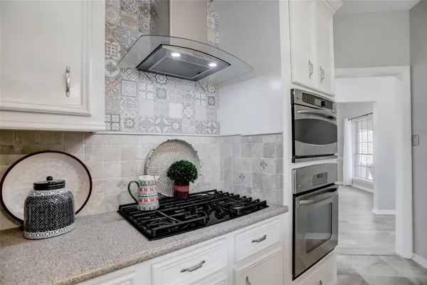 a kitchen with a stove and cabinets