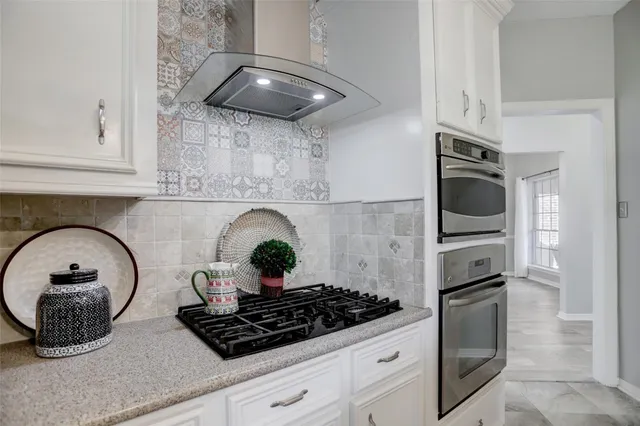 a kitchen with a stove and cabinets