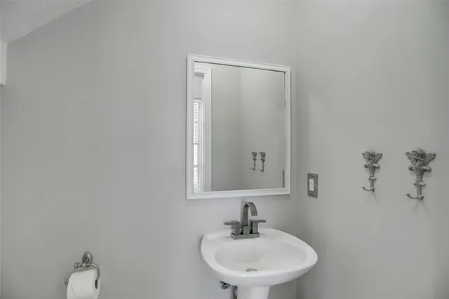 a bathroom with a sink a toilet and mirror