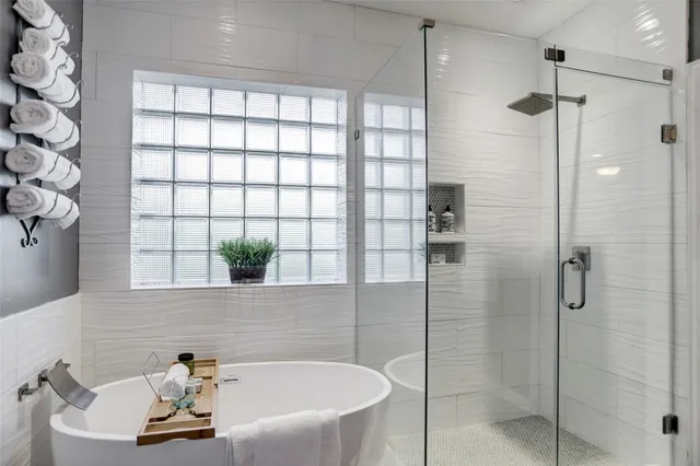 a bathroom with a bathtub and shower