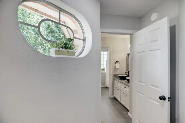 a view of a livingroom with wooden floor and a ceiling fan