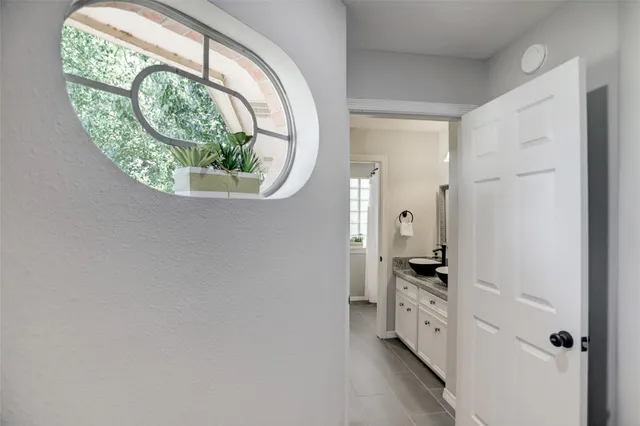 a view of a livingroom with wooden floor and a ceiling fan