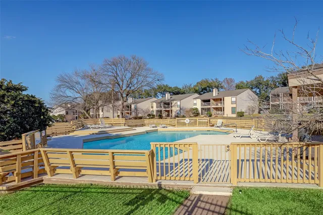 a view of a street sign under a large tree
