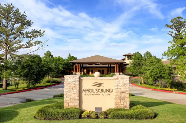 a view of a house with a big yard and large trees