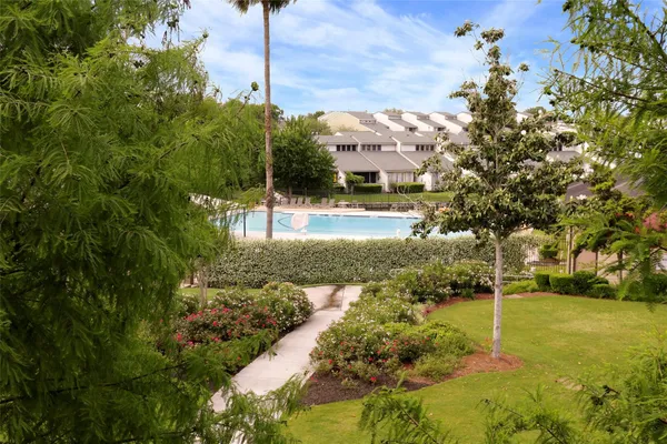 a view of a house with a yard and a lake view