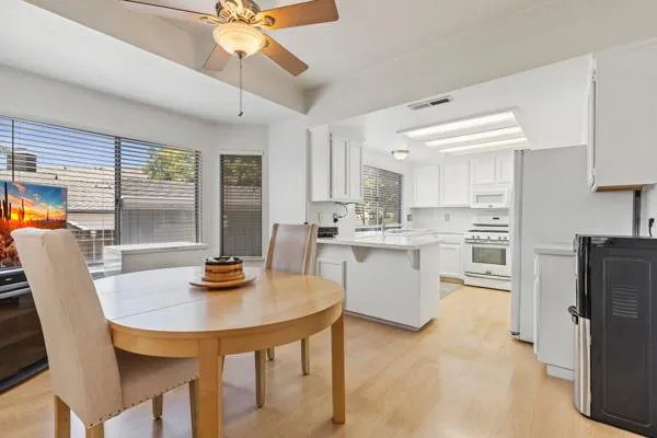 a kitchen with sink a center island and cabinets