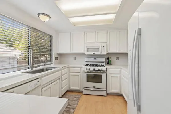 a view of an empty room with a fireplace and a window
