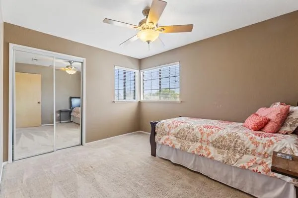 an empty room with fan and windows