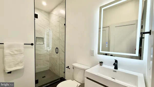 a bathroom with a sink toilet and vanity