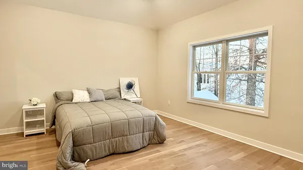 a spacious bedroom with a bed and a table