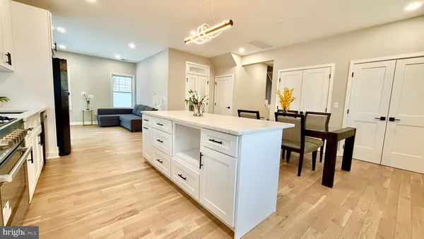 a kitchen with stainless steel appliances kitchen island granite countertop a stove sink and cabinets
