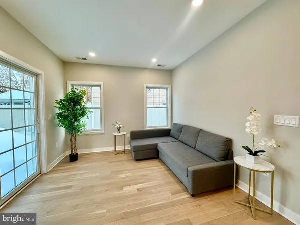 a living room with furniture and a potted plant
