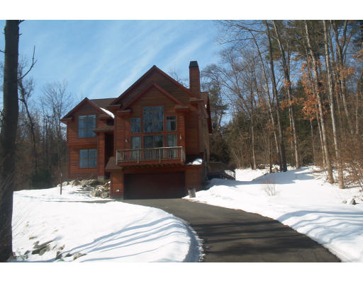 a view of a house with snow on the road