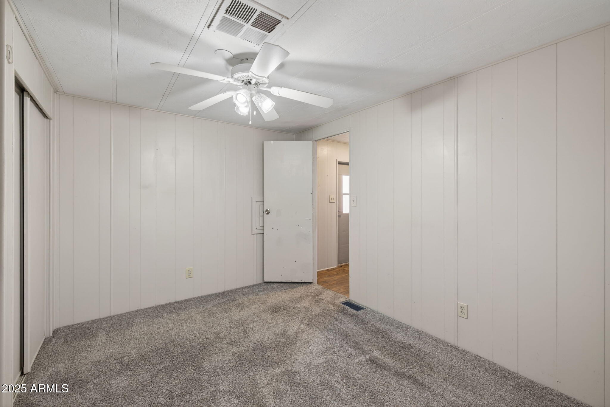 201 South Greenfield Road, Unit 310 Mesa, AZ 85206 - Photo 17 of 34 an empty room with a chandelier fan and a ceiling fan