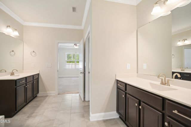 a spacious bathroom with a sink and a mirror