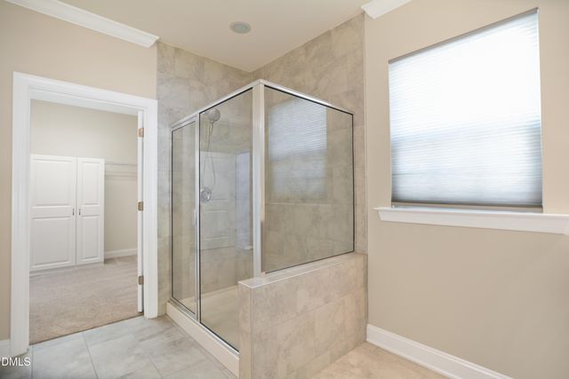 a bathroom with a glass shower door
