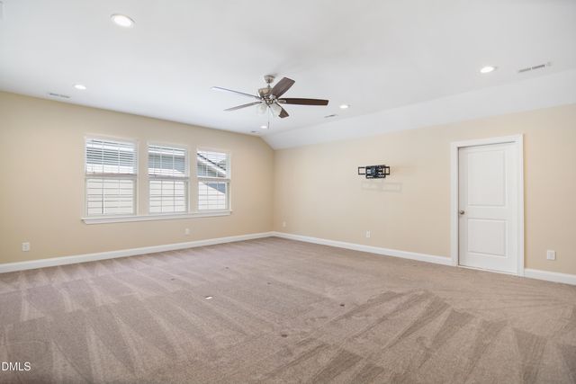 a view of an empty room with a ceiling fan