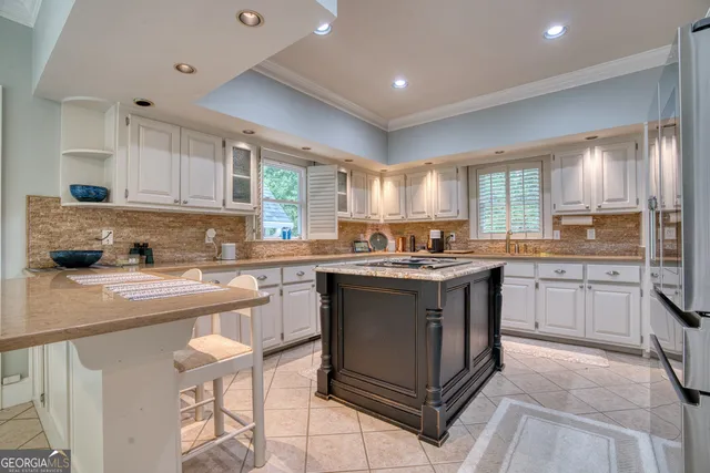 a kitchen with stainless steel appliances granite countertop a stove a sink dishwasher and a refrigerator