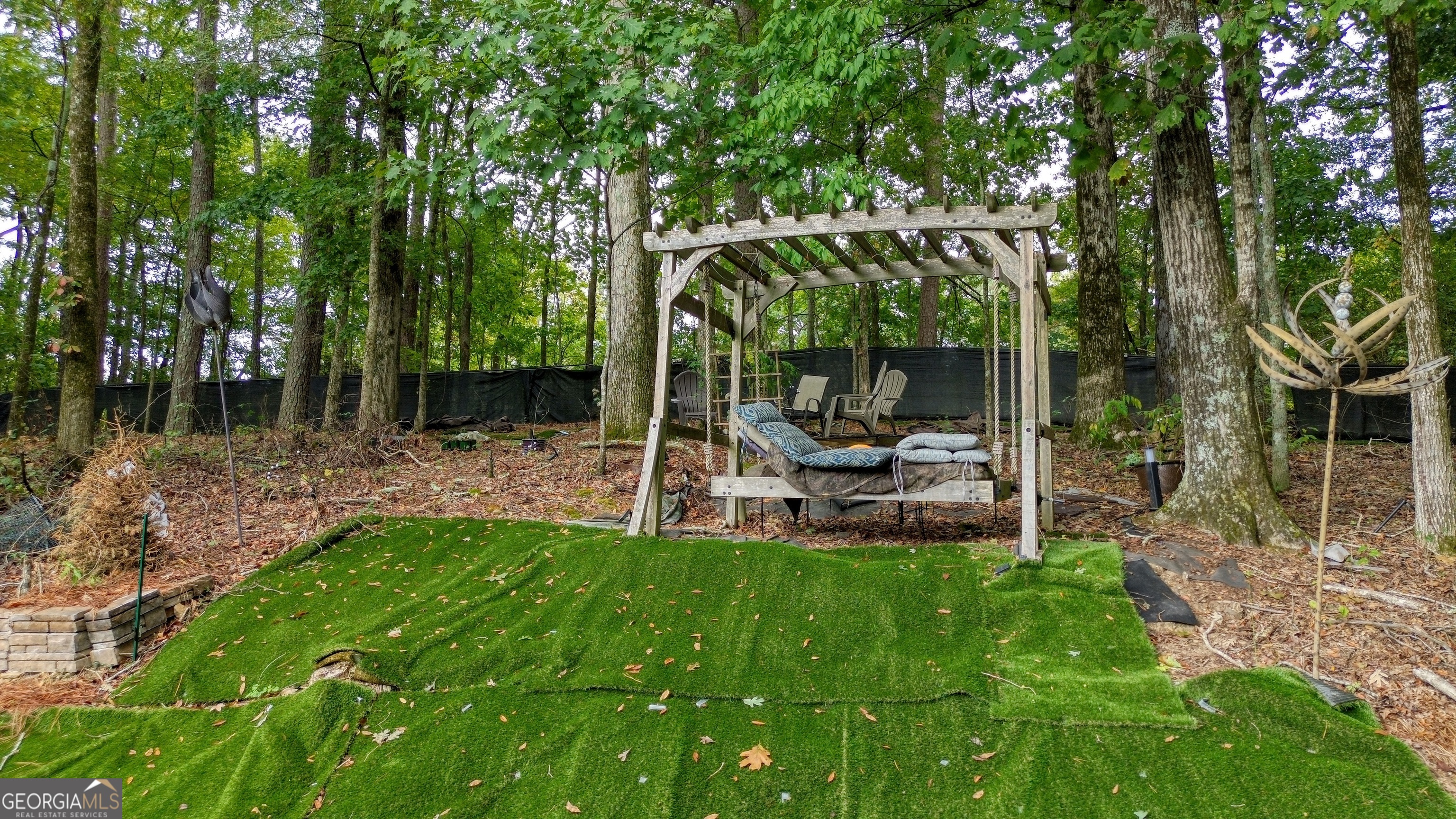 4 Rivermont Drive Southwest Rome, GA 30165 - Photo 44 of 55 a view of a chair and table in backyard of the house