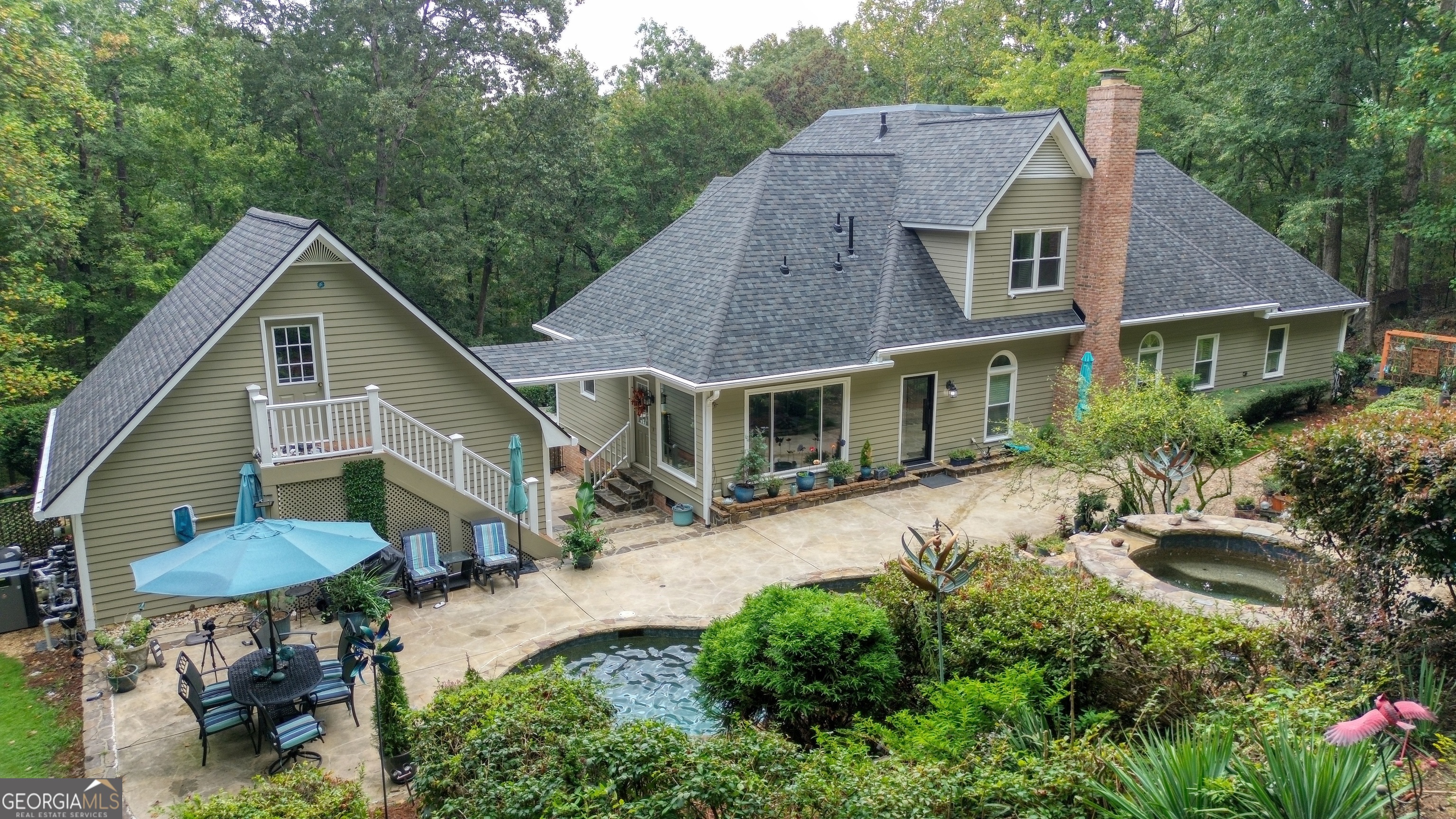 4 Rivermont Drive Southwest Rome, GA 30165 - Photo 46 of 55 a aerial view of a house with table and chairs under an umbrella