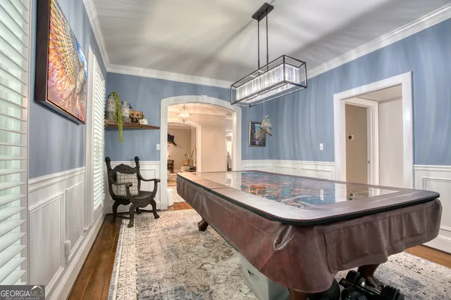 a dining room with a table chairs and a wooden floor