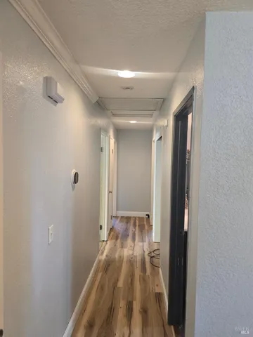 a view of hallway with wooden floor