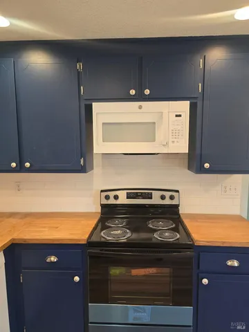 a stove top oven sitting inside of a kitchen
