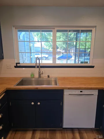 a kitchen with a sink window and cabinets