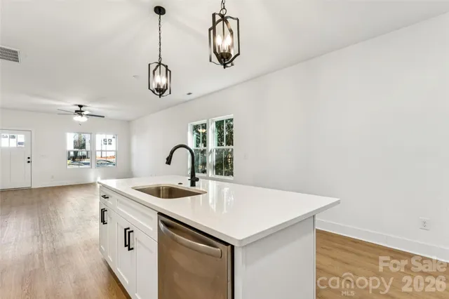 a view of a kitchen with a sink and cabinets