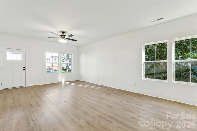 wooden floor in an empty room with a window