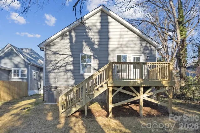 a view of a house with a wooden deck