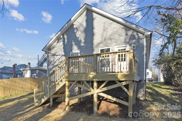 a view of a house with a wooden deck