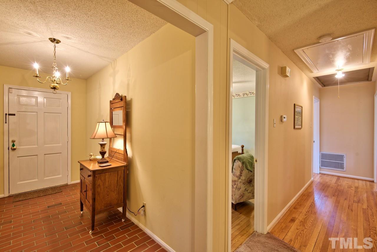 3607 Cole Mill Road Durham, NC 27712 - Photo 14 of 25 This is a picture of the Entry and Hallway. The pull down attic stairs are located in the hall. The attic is floored.
