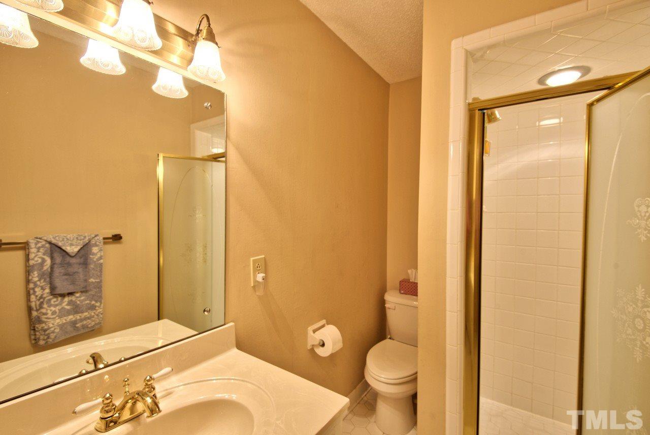 3607 Cole Mill Road Durham, NC 27712 - Photo 19 of 25 The Hall Bathroom features a walk in tile shower.