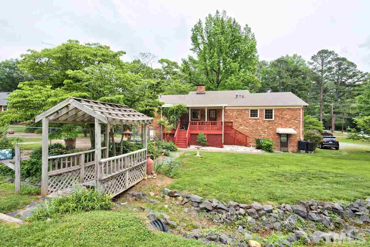 3607 Cole Mill Road Durham, NC 27712 - Photo 23 of 25 The Bridge way adds a unique feature to the yard and allows easy access to the large detached storage area.