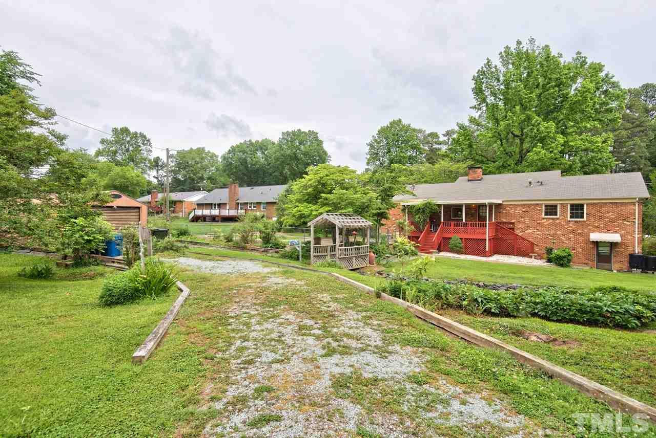3607 Cole Mill Road Durham, NC 27712 - Photo 25 of 25 The Bridge way adds a unique feature to the yard and allows easy access to the large detached storage area.