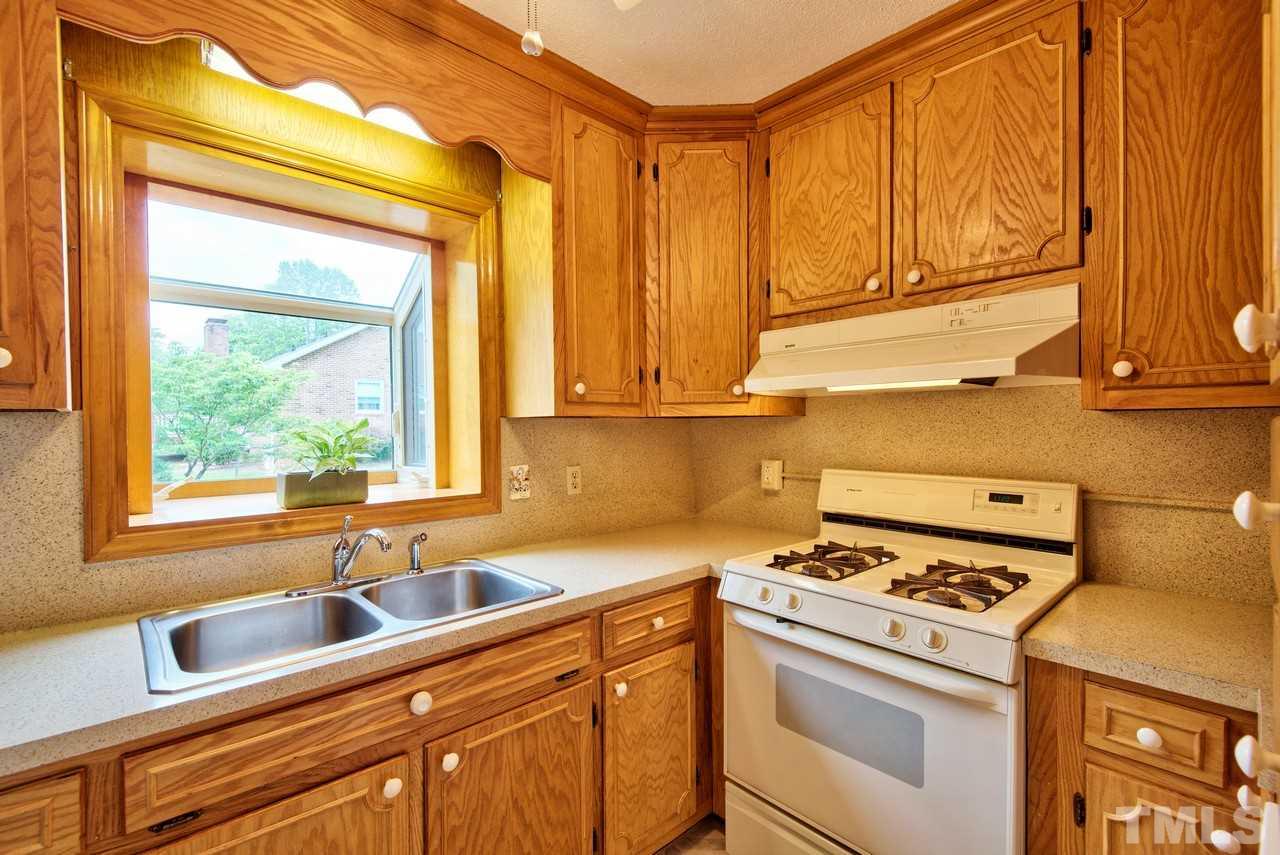 3607 Cole Mill Road Durham, NC 27712 - Photo 9 of 25 The kitchen has white appliances and gas stove. The extended window is perfect for an herb garden.