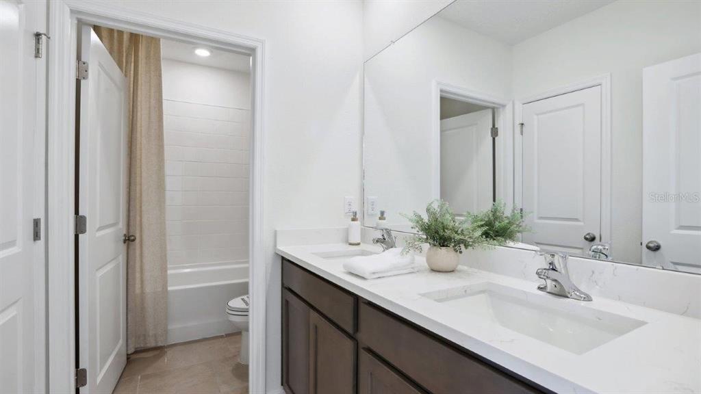 2306 Rikkola Lane Wesley Chapel, FL 33543 - Photo 13 of 28 a bathroom with a sink and a mirror