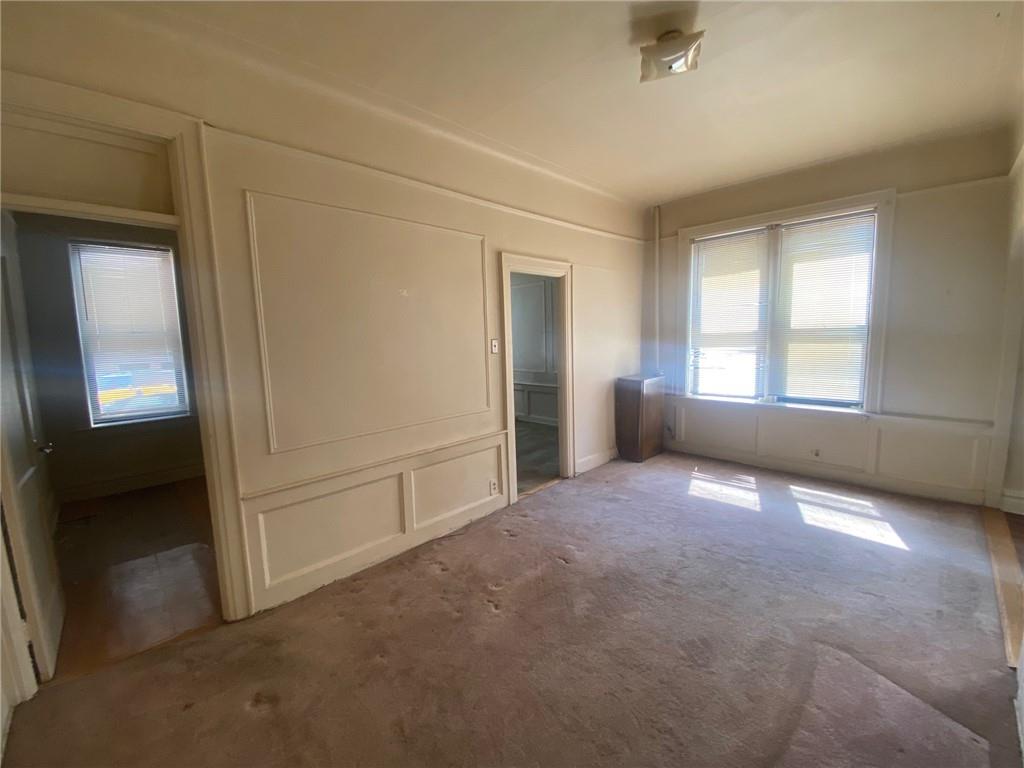 1175 66th Street Brooklyn, NY 11219 - Photo 12 of 17 an empty room with windows