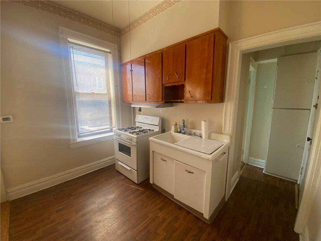 1175 66th Street Brooklyn, NY 11219 - Photo 7 of 17 a utility room with cabinets washer and dryer