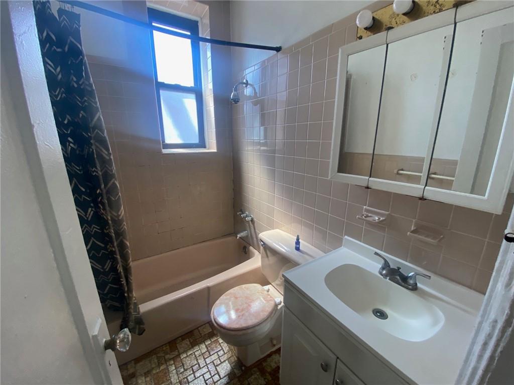 1175 66th Street Brooklyn, NY 11219 - Photo 10 of 17 a bathroom with a sink toilet and shower
