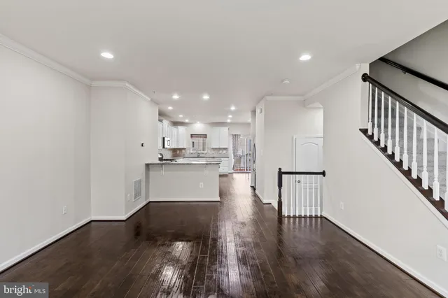 a view of kitchen with wooden floor and electronic appliances